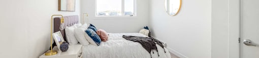 a bedroom with a bed and a window