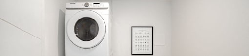 a white washer and dryer in a room with a washing machine