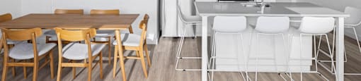 a kitchen and dining room with a table and chairs