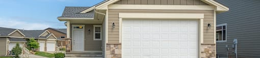 A house with a driveway and garage door.