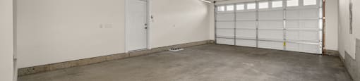 A large garage space with a roll-up door.
