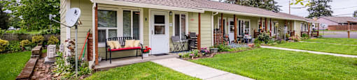 the front of a house with a yard and a sidewalk
