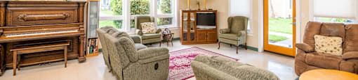 a living room with furniture and a piano
