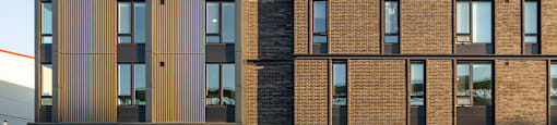 a rendering of a brick building with wood and glass windows