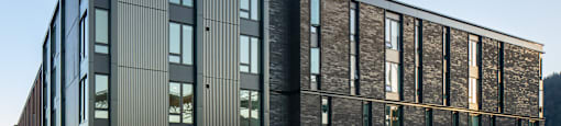 a large building with a sidewalk in front of it