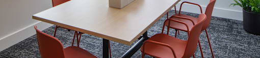 a meeting room with a table and chairs and a man walking down the street