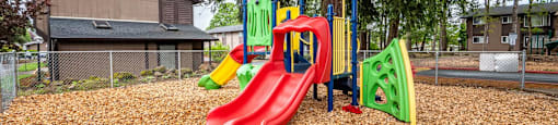 our playground is equipped with slides and a tree