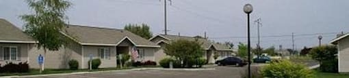 an empty street in a neighborhood with houses