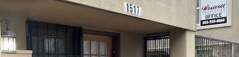 a building with two doors and a sign for an office