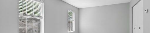 A room with a window and a door.