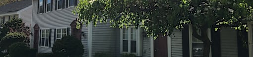 A house with a tree in front of it.