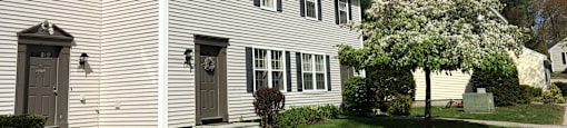 A white house with a grey door and windows.