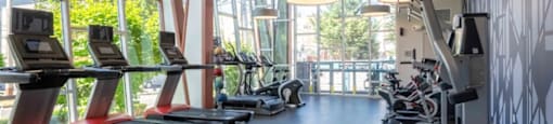 Gym with treadmills, elliptical machines, and other exercise equipment at Astro, Seattle, WA, Washington