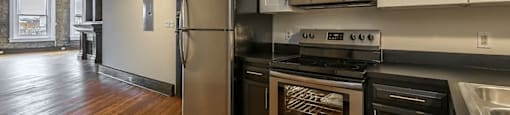 a kitchen with white cabinets and stainless steel appliances