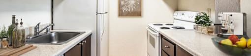 full kitchen with white appliances and wood flooring at the preserve at Eagles Landing Apartments, Everett, WA