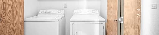 a small laundry room with two washes and a dryer at Eagles Landing Apartments, Everett, 98204