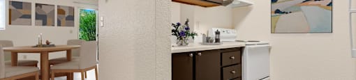 a kitchen and dining room area with a table and chairs and a wall at Eagles Landing Apartments, Washington  