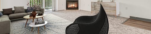 a living room with a black chair and a fireplace at Sage Apartments, Everett, WA, 98204