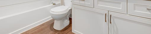 a white bathroom with a toilet and a sink at Sage Apartments, Washington