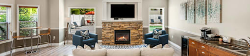 a living room with a couch and chairs and a fireplace at Sage Apartments, Washington, 98204