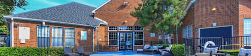 a large swimming pool in front of a brick building at Villas of Sorrento Apartments, Texas
