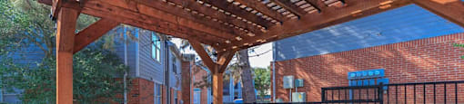 a patio with a picnic table and a grill at Villas of Sorrento Apartments, Dallas, TX, 75241