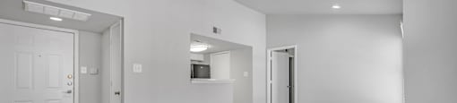a living room with white walls and a ceiling fan at Villas of Sorrento Apartments, Dallas, TX, 75241