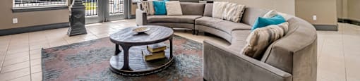 a living room with a couch and a table at Villas of Sorrento Apartments, Dallas