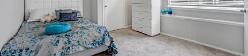 a bedroom with a bed and a large window at Villas of Sorrento Apartments, Dallas, TX, 75241