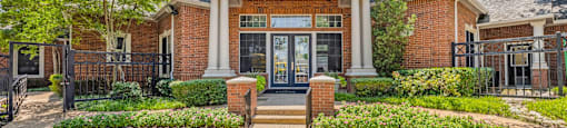 Front of the leasing office framed by landscaping at Villas of Sorrento Apartments, Dallas, TX