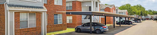 a car is parked under an overpass in a parking lot at Villas of Sorrento Apartments, Dallas, Texas