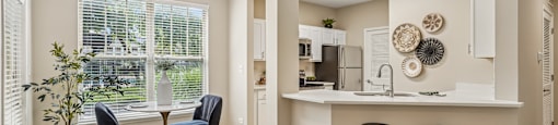 A kitchen with a bar area and two chairs.