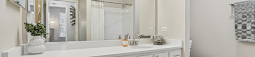 A white bathroom with a toilet and sink.