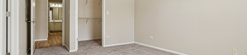A room with a ceiling fan and carpeted floor.