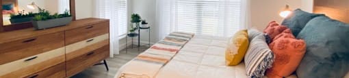 bedroom with a bed and a dresser at Mainstreet Apartments, Clearwater
