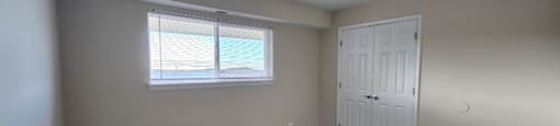 A room with a brown carpet and a white door.
