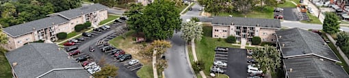 A bird's eye view of a residential area with houses and cars.