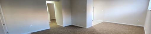 A room with carpeted floor and white walls.