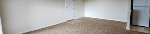 A room with a carpeted floor and a white ceiling.