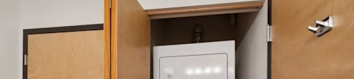 an empty laundry room with a washer and dryer