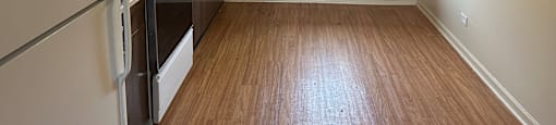Kitchen with a white refrigerator and wooden floors.at The Countryside, Illinois ?