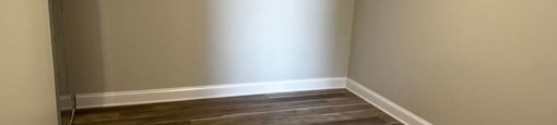 A room with wooden flooring and a door at Evelyn Apartments, Illinois