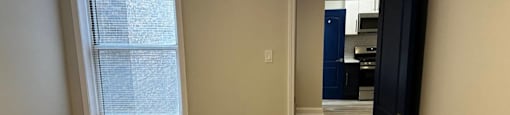 Bedroom with a wooden floor and a black door at Evelyn Apartments, Oak Park, 60304