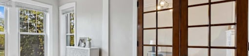 a living room with a wooden door and a window at The Bryant at Oak Park I & II, Oak Park, IL 60302