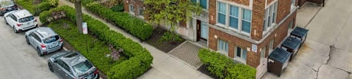 an aerial view of a brick apartment building with a parking lot at The Bryant at Oak Park I & II, Illinois, 60302