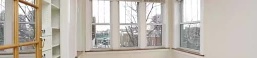 an empty living room with a closet and a window at The Bryant at Oak Park I & II, Illinois, 60302
