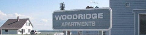 a sign for woodridge apartments in front of a house at Woodridge Apartments, Alaska, 99611