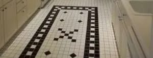 a white kitchen with a black and white tile floor at Bryant II