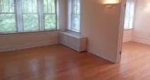 Living room with a wooden floor and windows at Bryant II