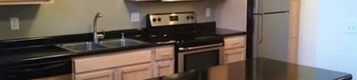 Modern Kitchen with appliances and cabinets along with dishwasher at Boston Lofts, Wisconsin, 53203